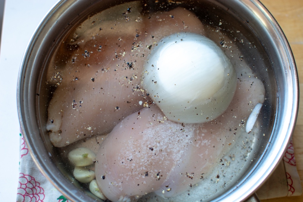 Chicken cooking with onion in a pot