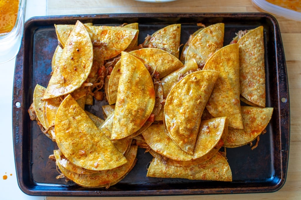 All the tacos on a baking sheet 