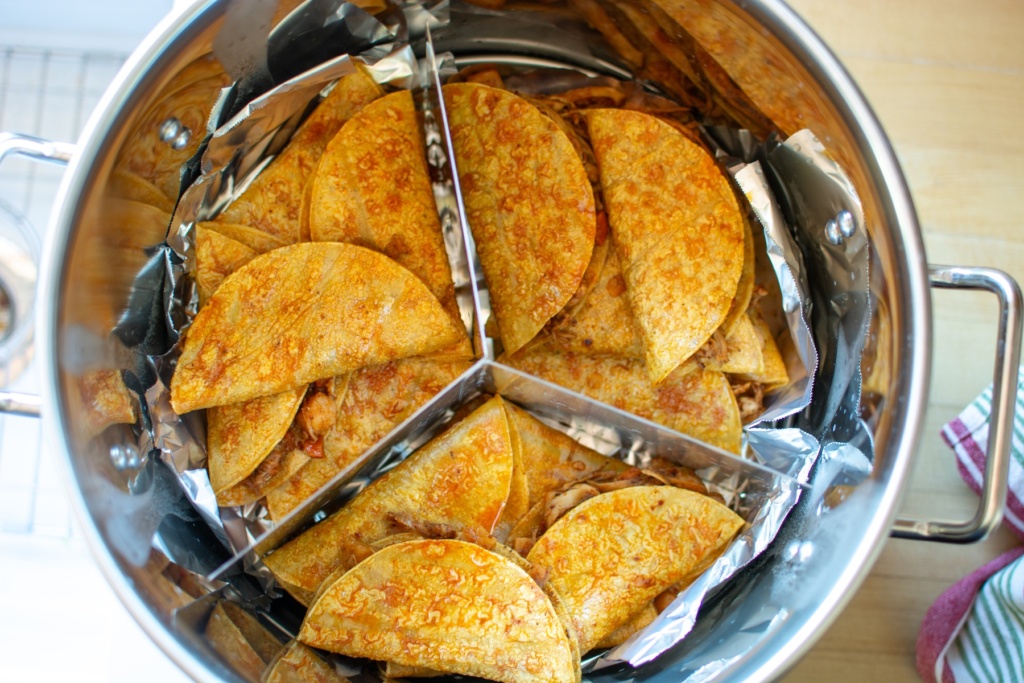 The tacos arranged in the steamer pot. 