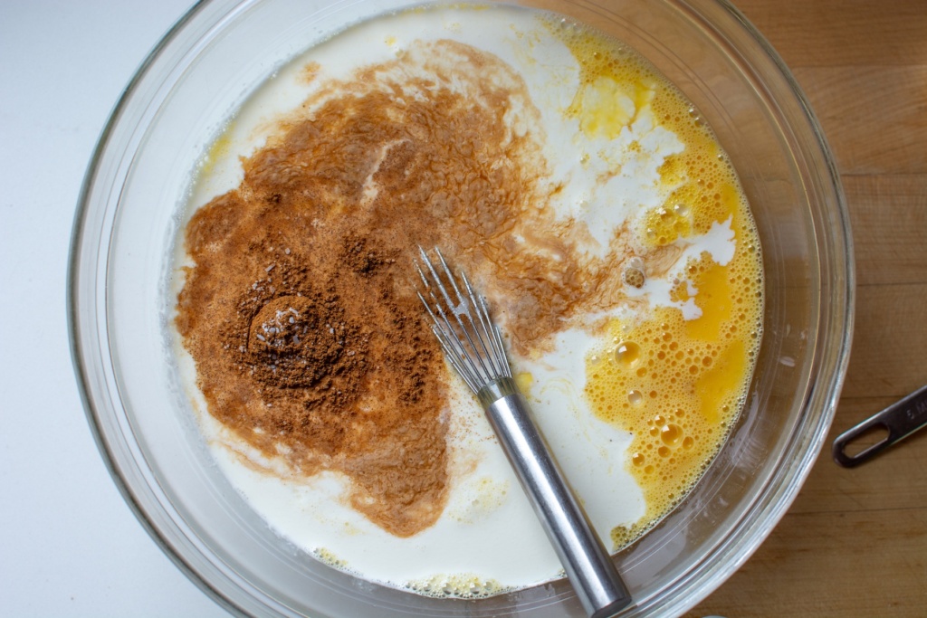 cinnamon on top of milk in a glass bowl