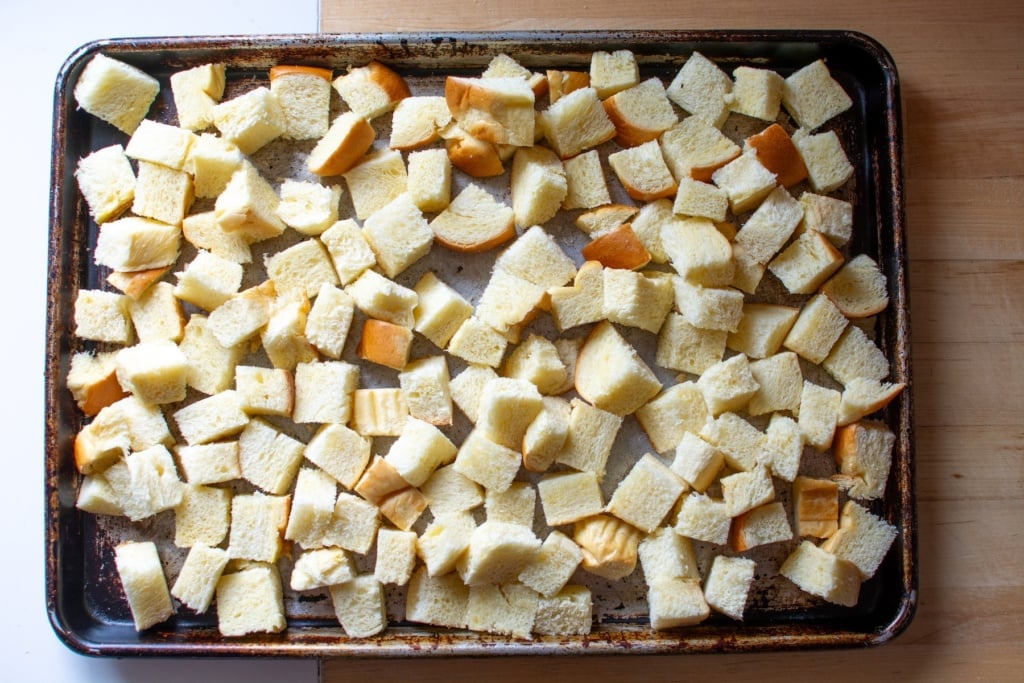 bread cubes on a baking sheet