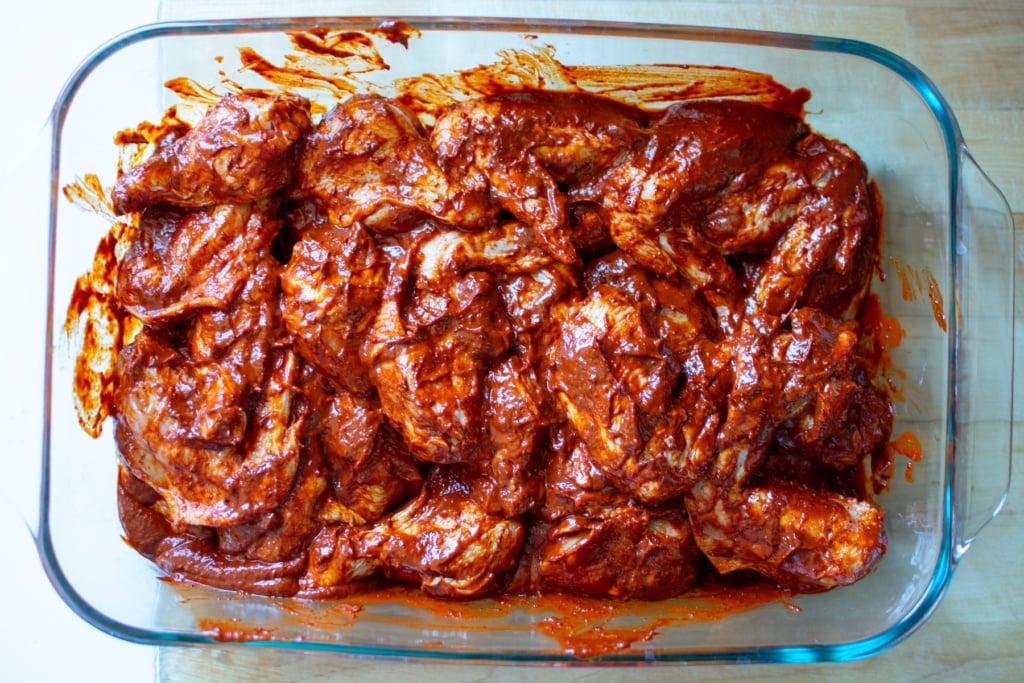 chicken wings in a bright red marinade