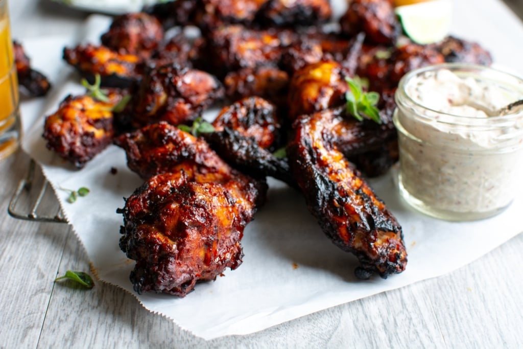al pastor chicken wings on a piece of parchment paper