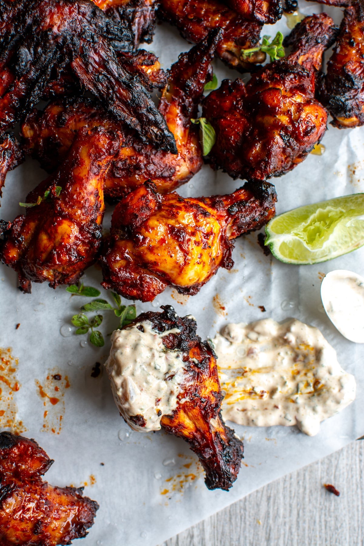 al pastor chicken wings dipped in sauce.