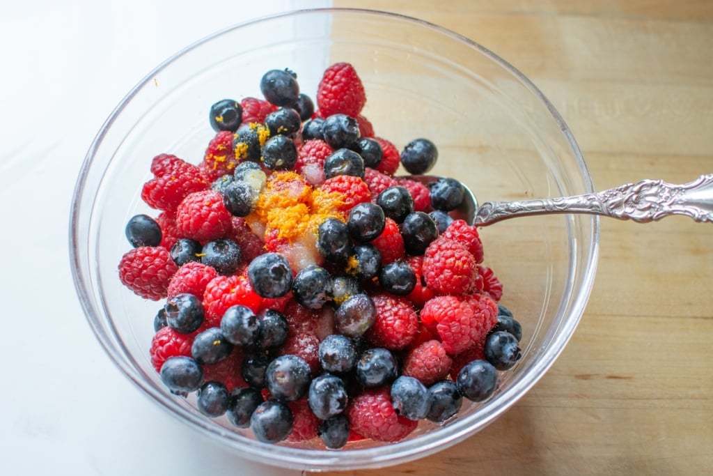 berries in a glass bowl with a spoon in it