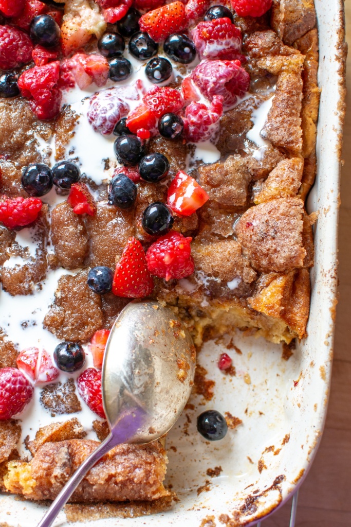 churro bread pudding with a piece taken out and a spoon in the dish