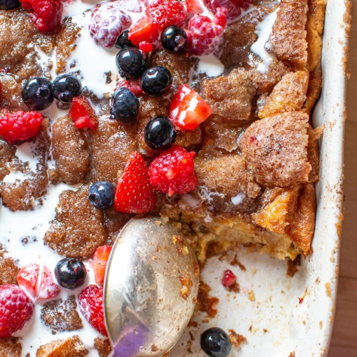 churro bread pudding with a piece taken out and a spoon in the dish