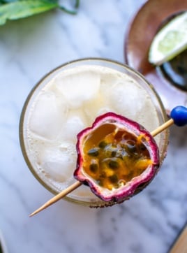 a passion fruit margarita with a passion fruit on top.
