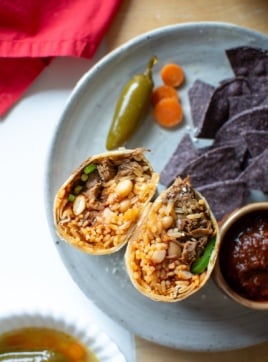 A shredded beef burrito cut in half