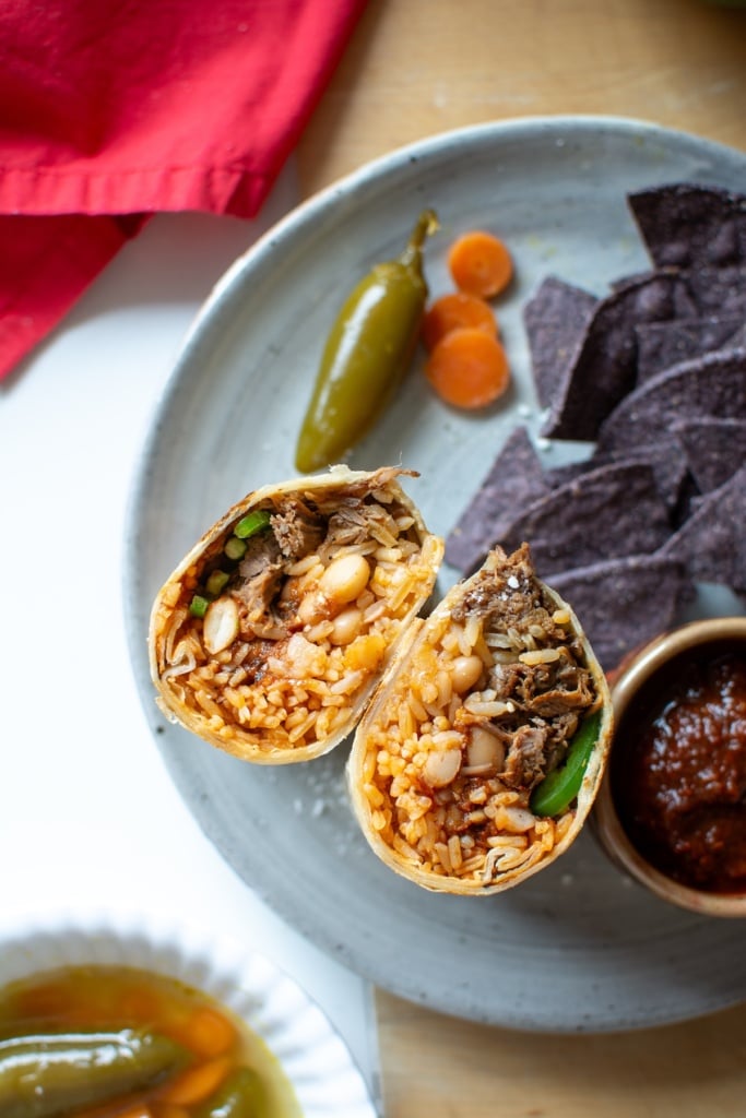 A shredded beef burrito cut in half