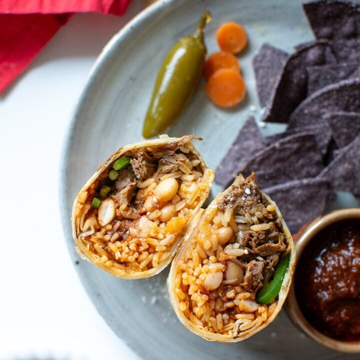 A shredded beef burrito cut in half
