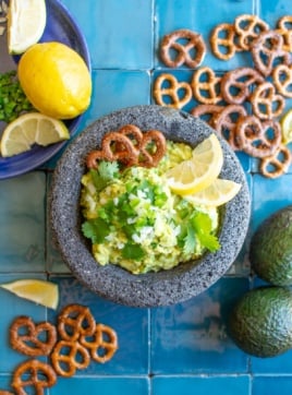 guacamole in a molcajete with pretzels