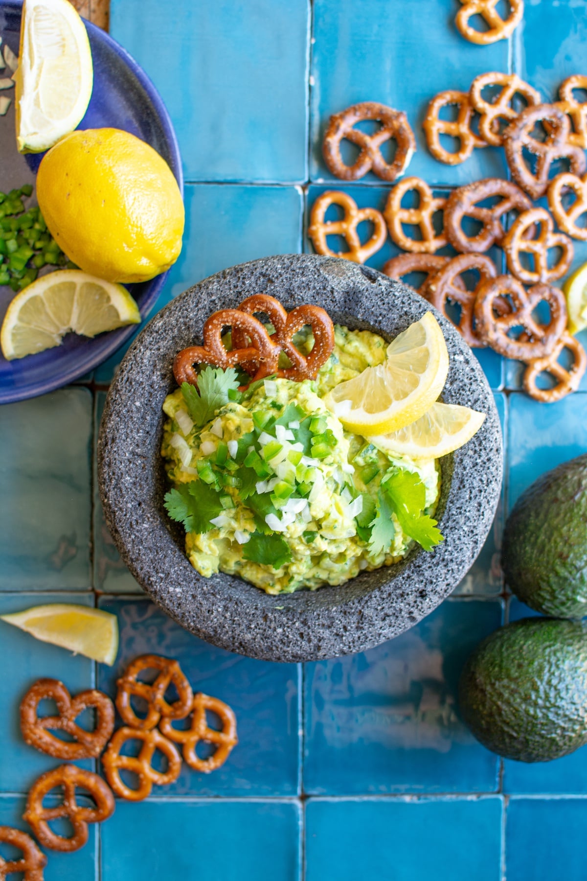 guacamole in a molcajete with pretzels