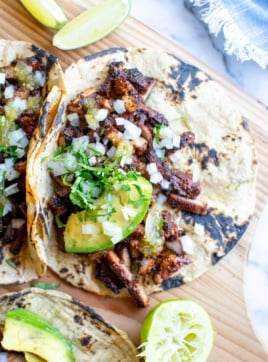 pork adobada tacos with onions on top
