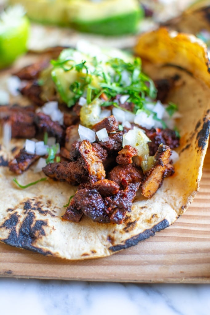 Pork adobada tacos with cilantro on top