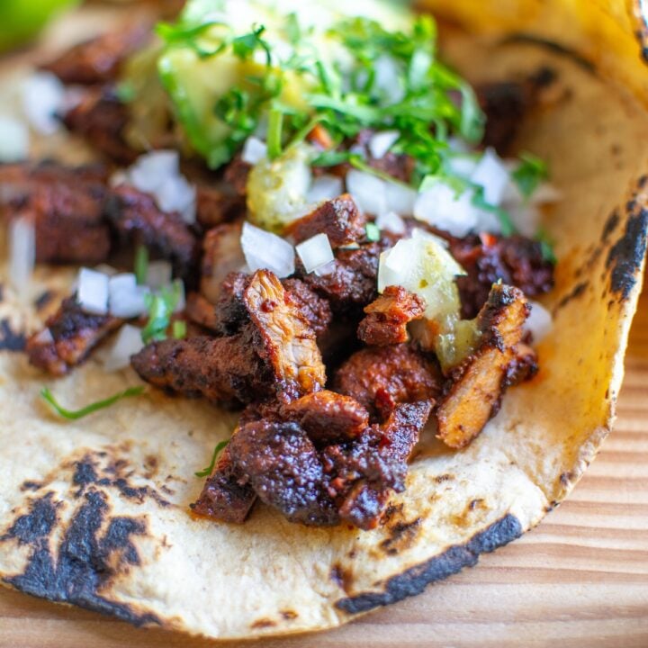 Pork adobada tacos with cilantro on top