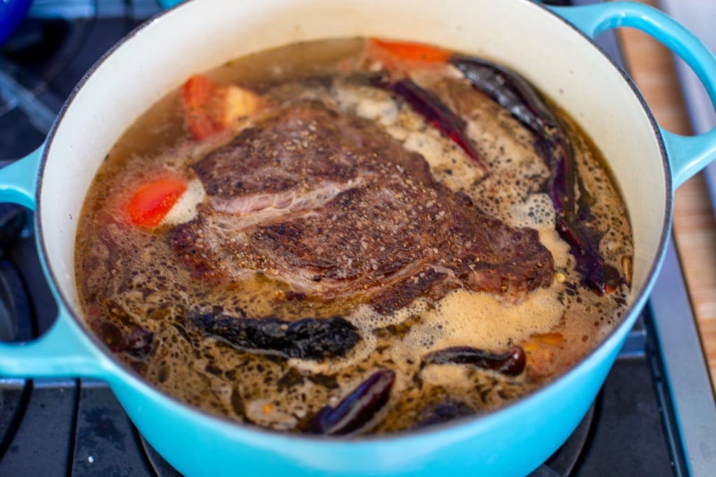 the beef in a pot covered with water