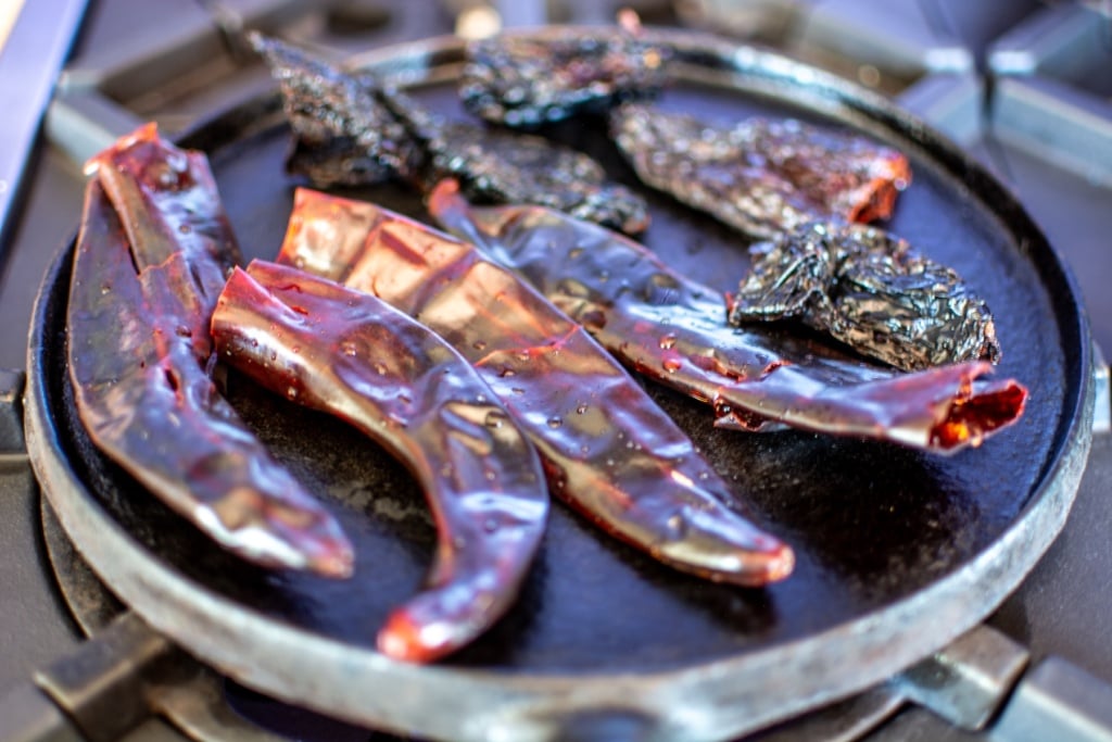 dried chiles on a comal toasting