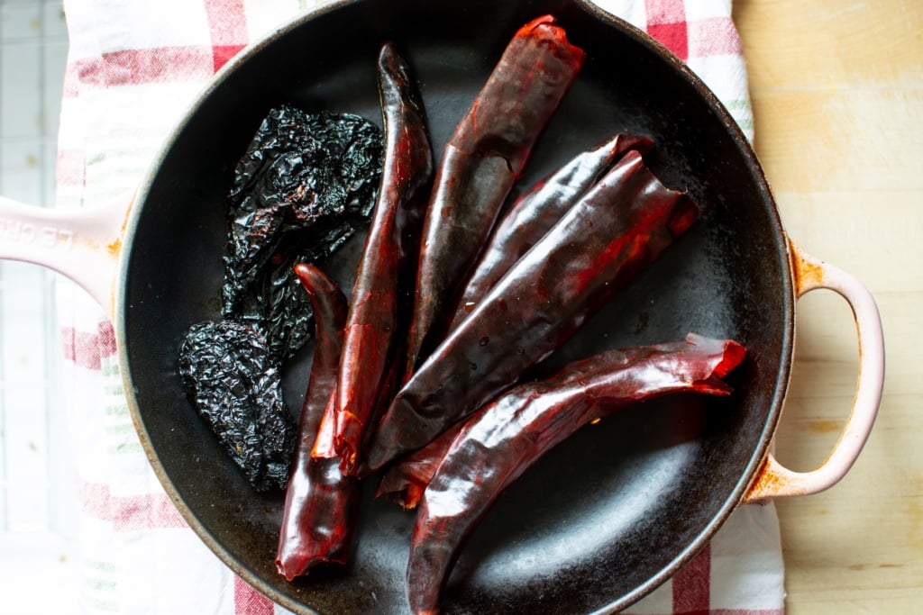 chiles toasting in a cast iron pan