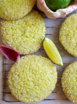several lime sugar cookies with a lime wedge