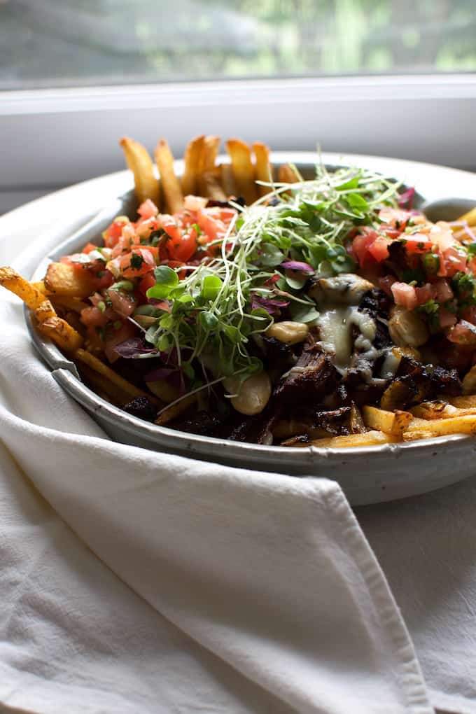 fries topped with shredded beef and sprouts