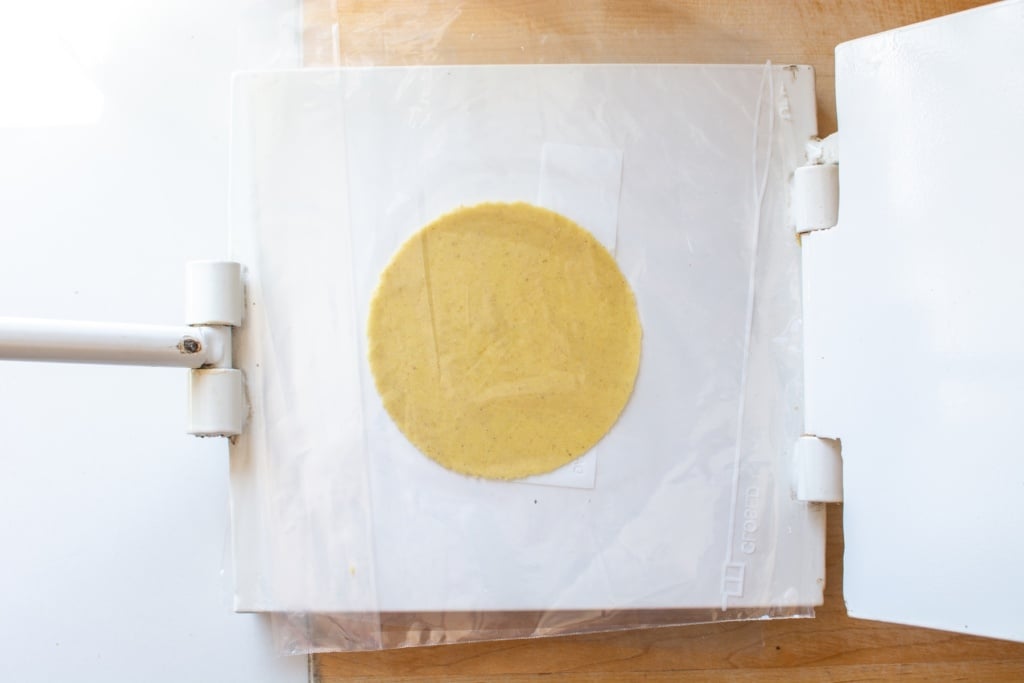 flattened dough using tortilla press