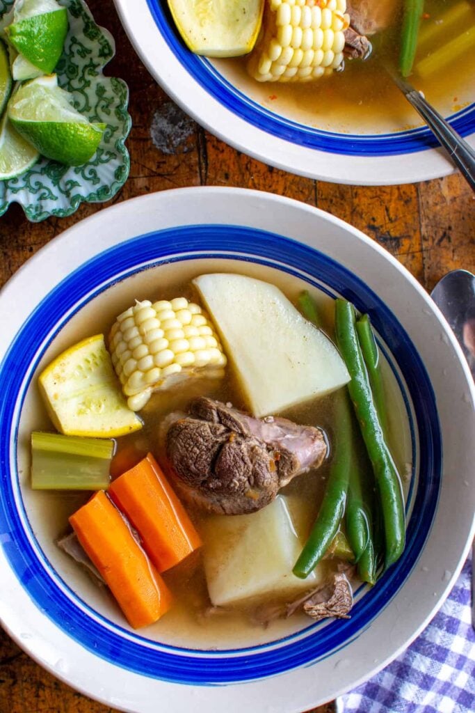 a bowl of beef soup with corn
