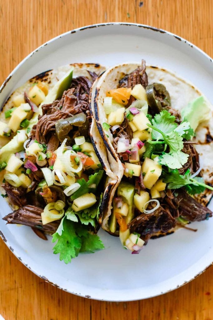 two beef tacos on a plate