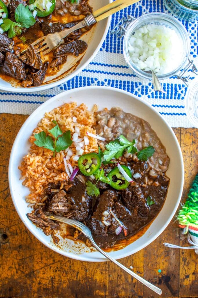 carne colorado on a white dish next to some onions