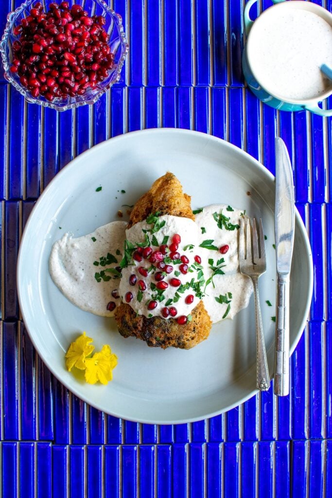 a stuffed chile topped with pomegranate