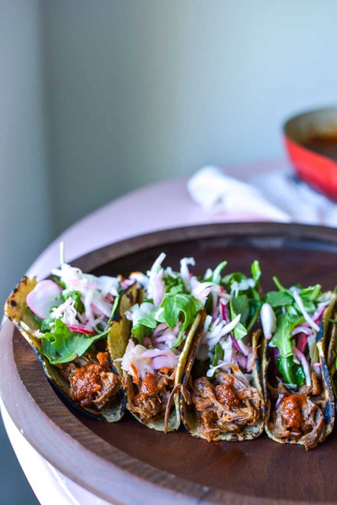 several beef tacos topped with lettuce