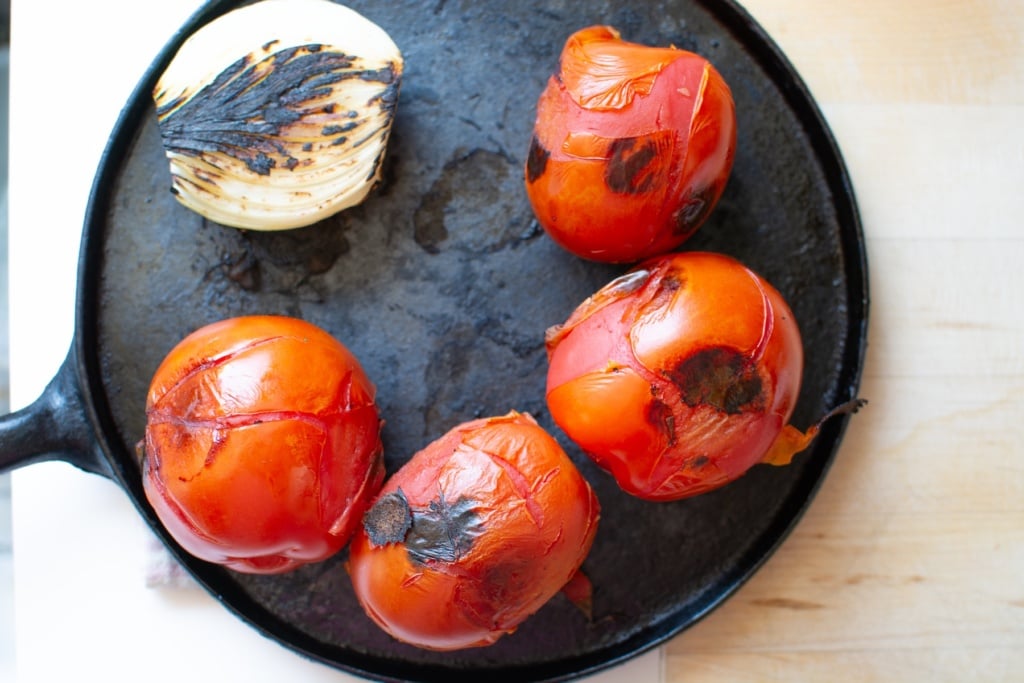 tomatoes and onion toasted in a comal