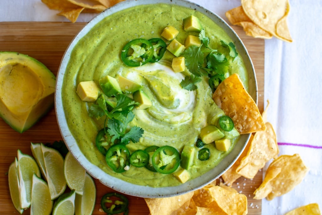 a bowl of salsa de aguacate with sliced jalapeños on top