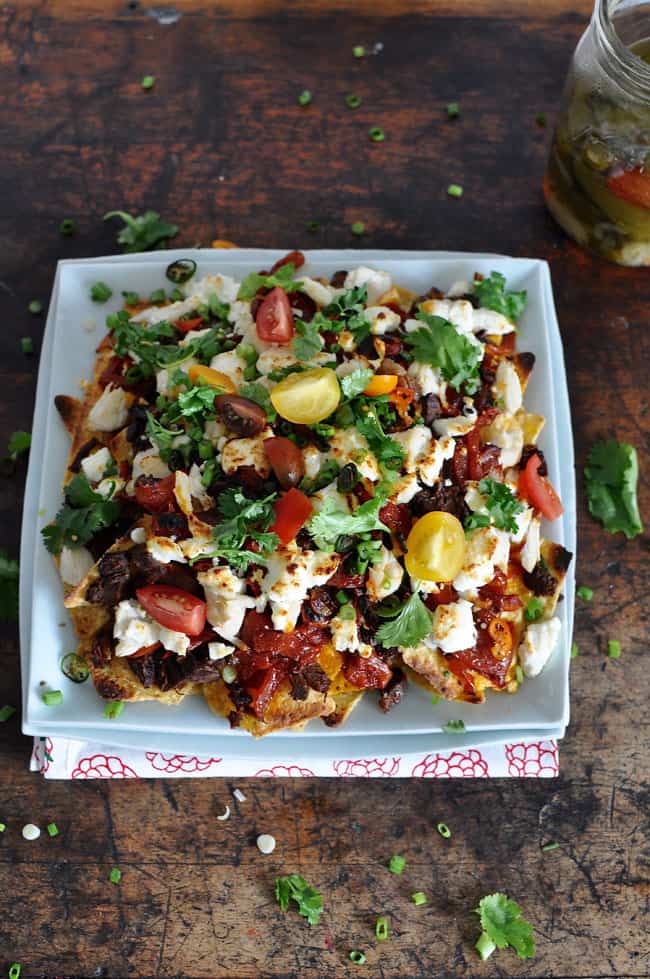 a plate of nachos topped with meat