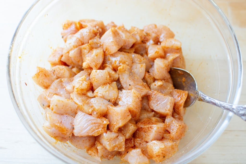 raw chicken cut up in a bowl