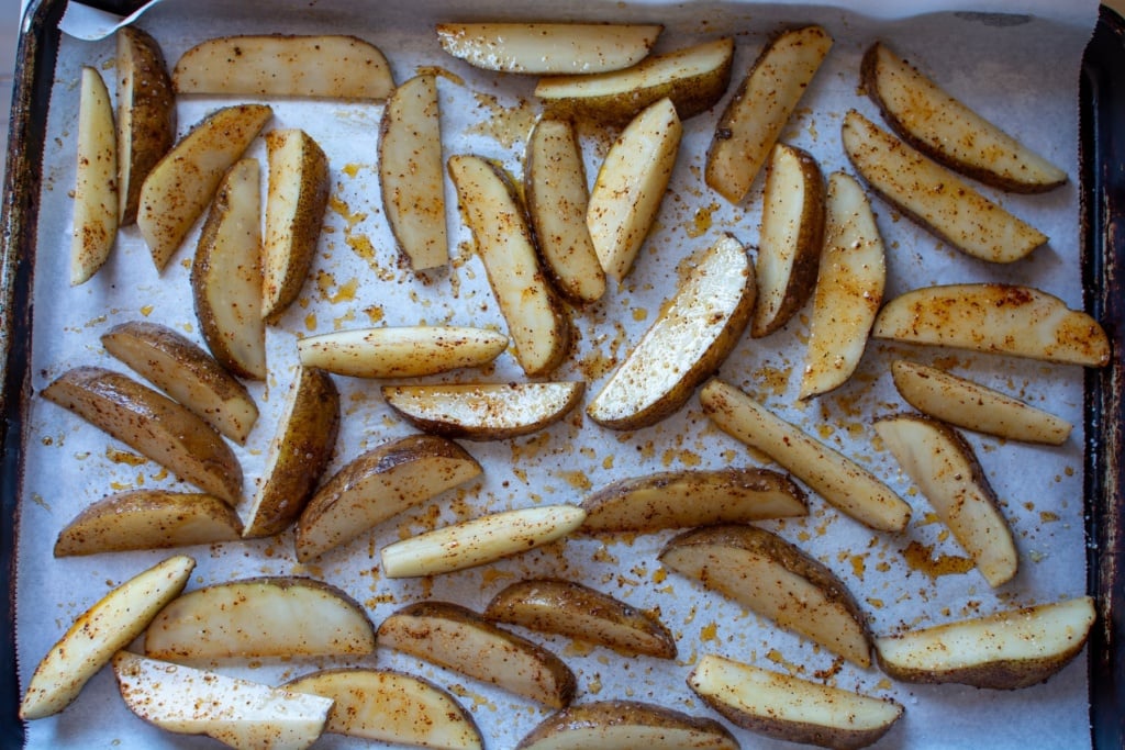 potato wedges on a baking sheet