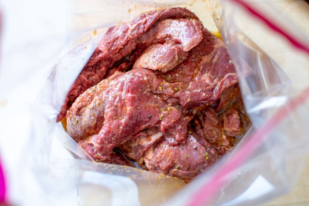 wet marinade on steak in a plastic bag