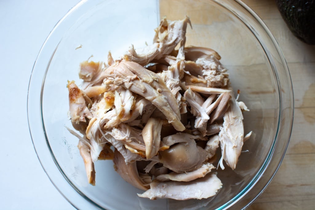 shredded chicken in a glass bowl