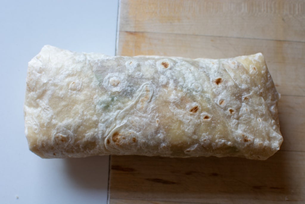 a chimichanga rolled on a counter