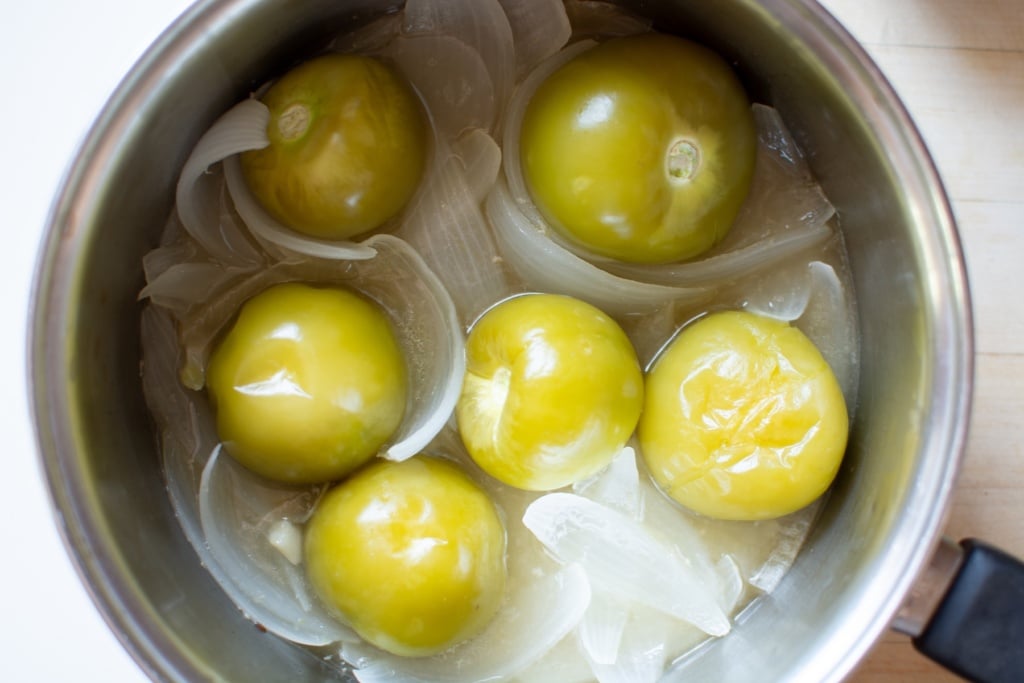 cooked tomatillos and onions in a saucepan