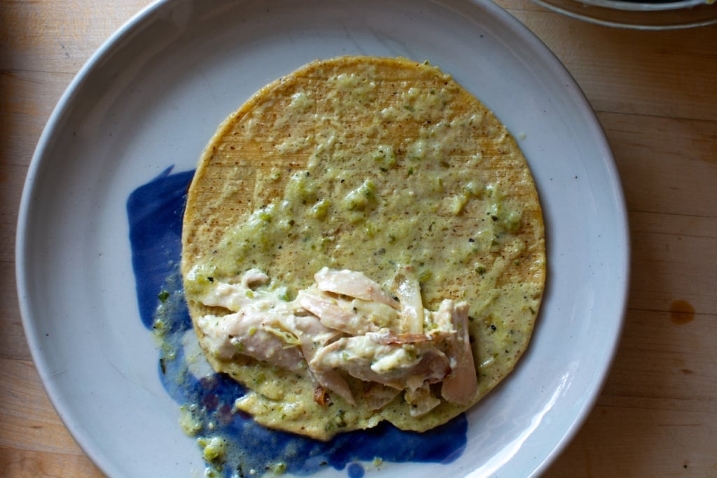 a tortilla filled with shredded chicken