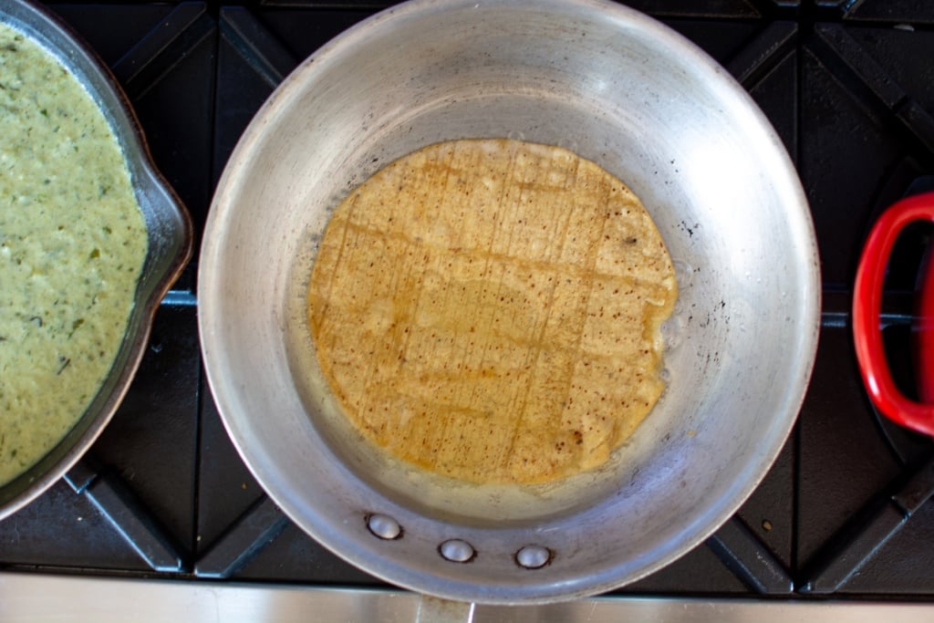 corn tortilla frying in a pan