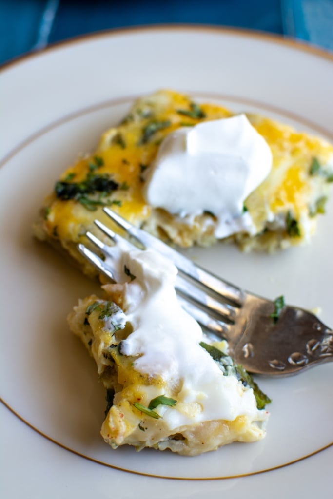 a piece of chile relleno casserole topped with sour cream