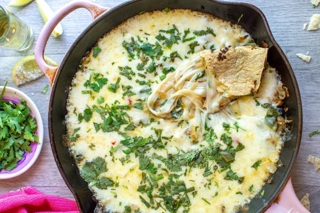 A skillet with queso in it with a tortilla on top
