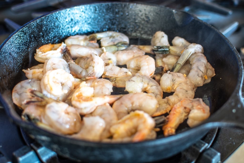 shrimp searing in a cast iron skillet