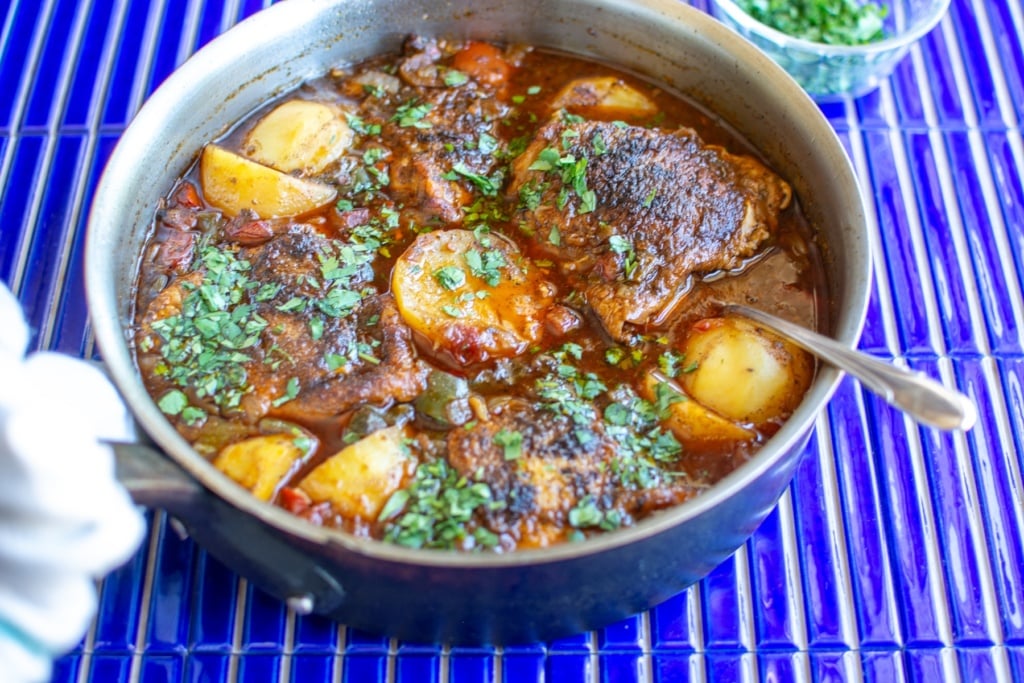 chicken guisado in a copper pot